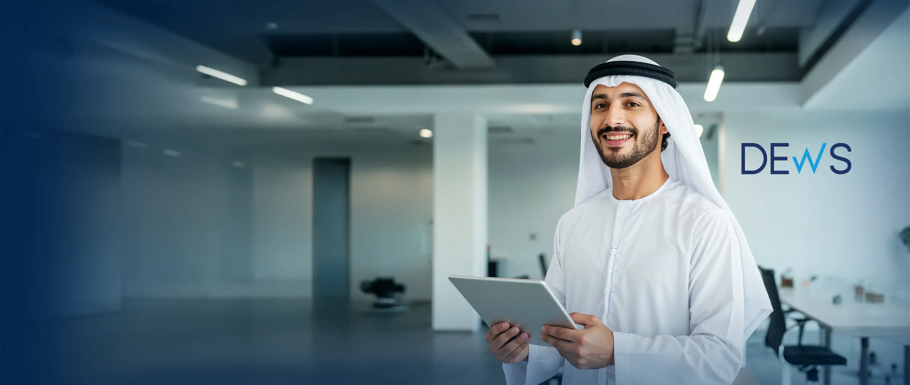 A smiling Emirati professional holding a tablet in a modern corporate office, representing the DEWS employee workplace savings plan by National Bonds.